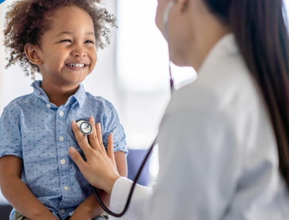 A doctor listening to a child’s heart